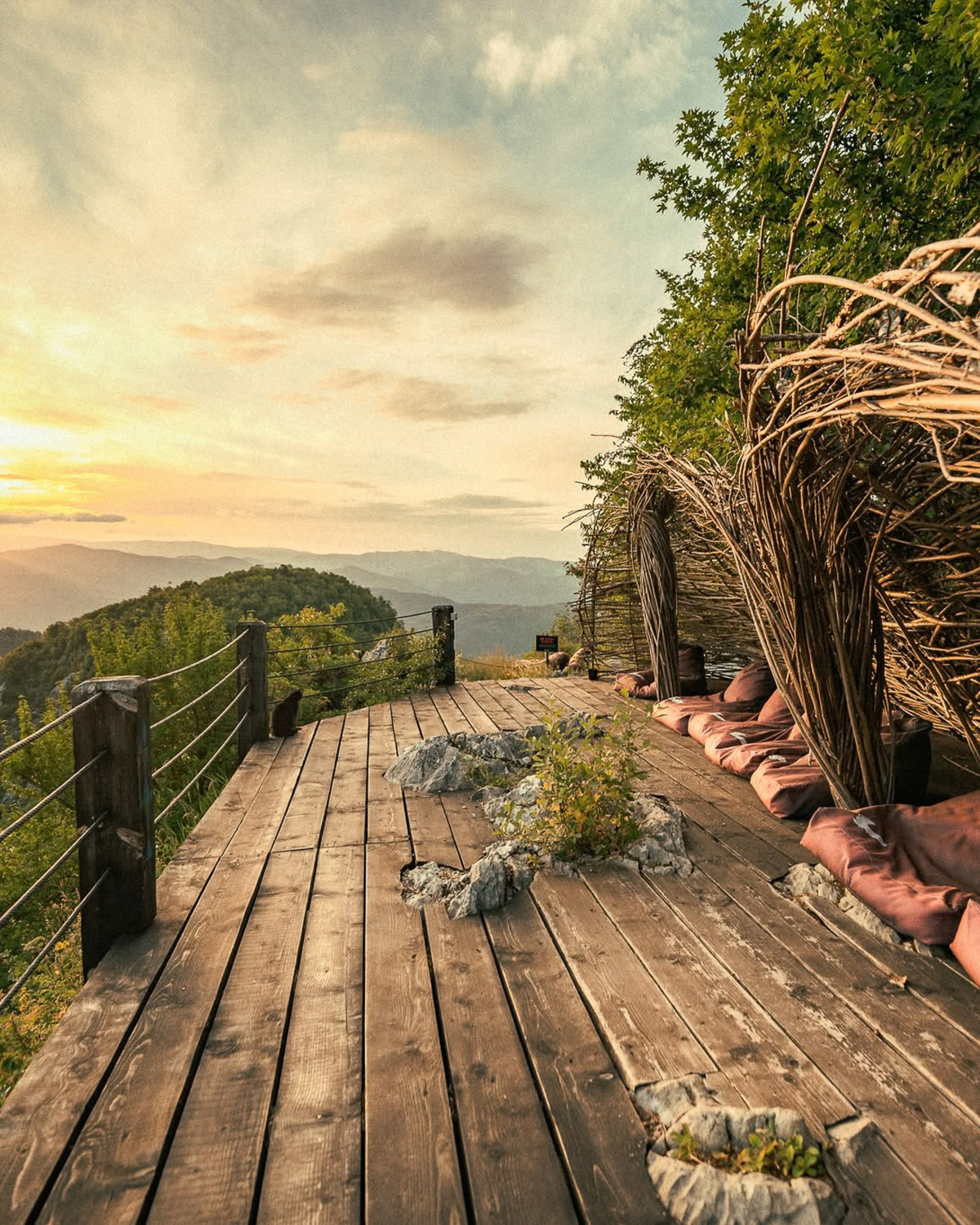 Terrace at Raven's Nest overlooking the mountains at sunset