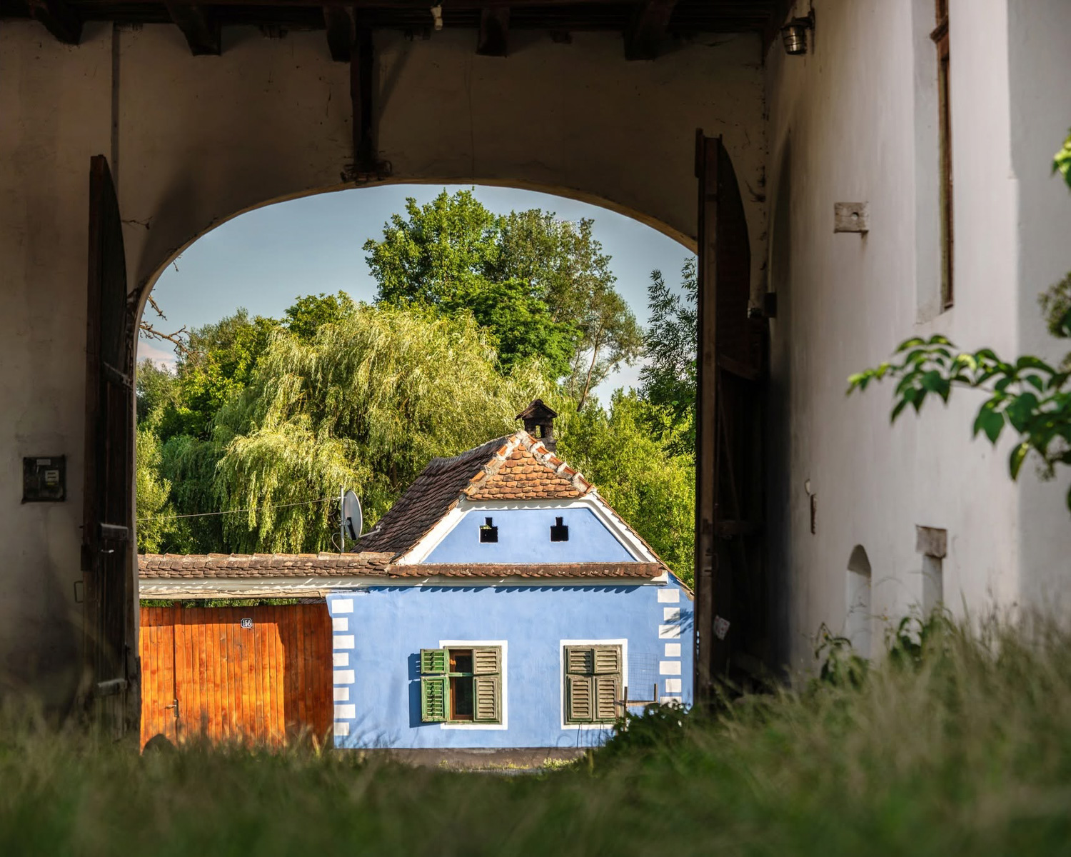 Traditional Transylvanian house seen through an archway in Viscri
